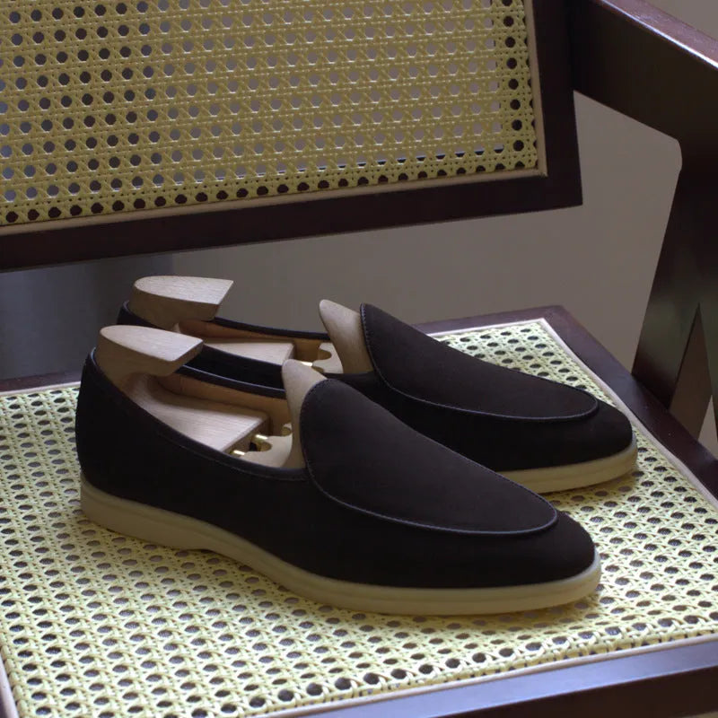 Men's brown genuine leather loafers with a TPR sole on a white background.