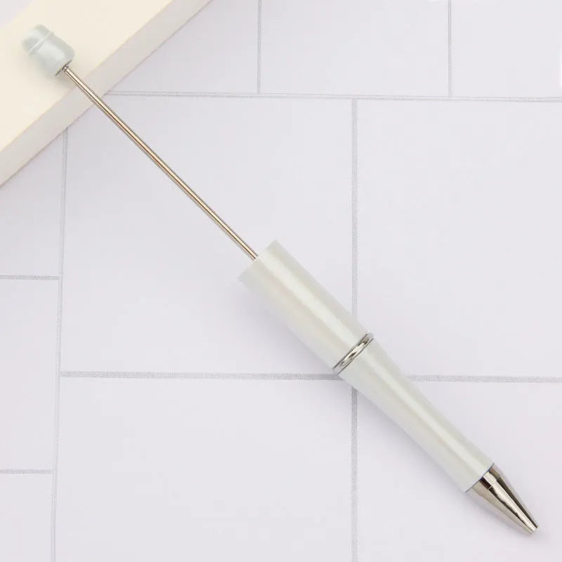 Creative ballpoint pen with multicoloured spinning plastic beads on a steel wire frame.