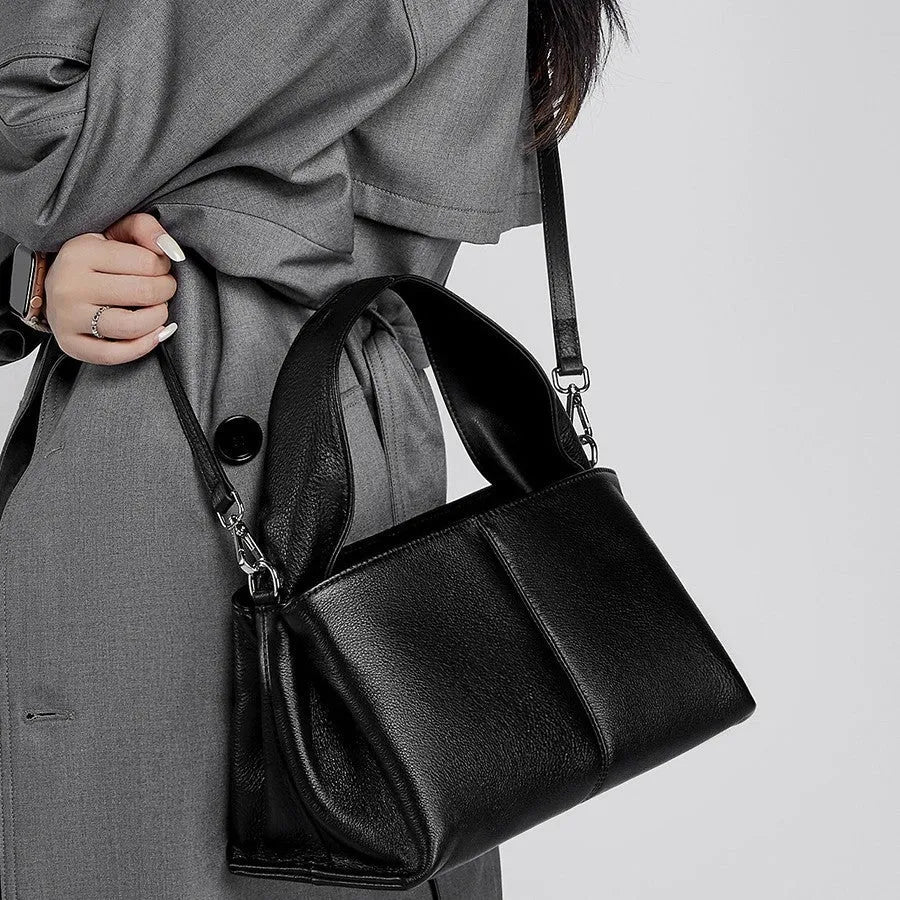 Women's genuine leather messenger bag in horizontal square shape with double shoulder strap, shown in apricot colour.
