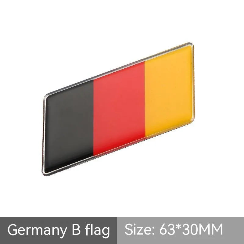 Aluminium parallelogram car sticker with national flag design measuring 6.3 by 3 cm