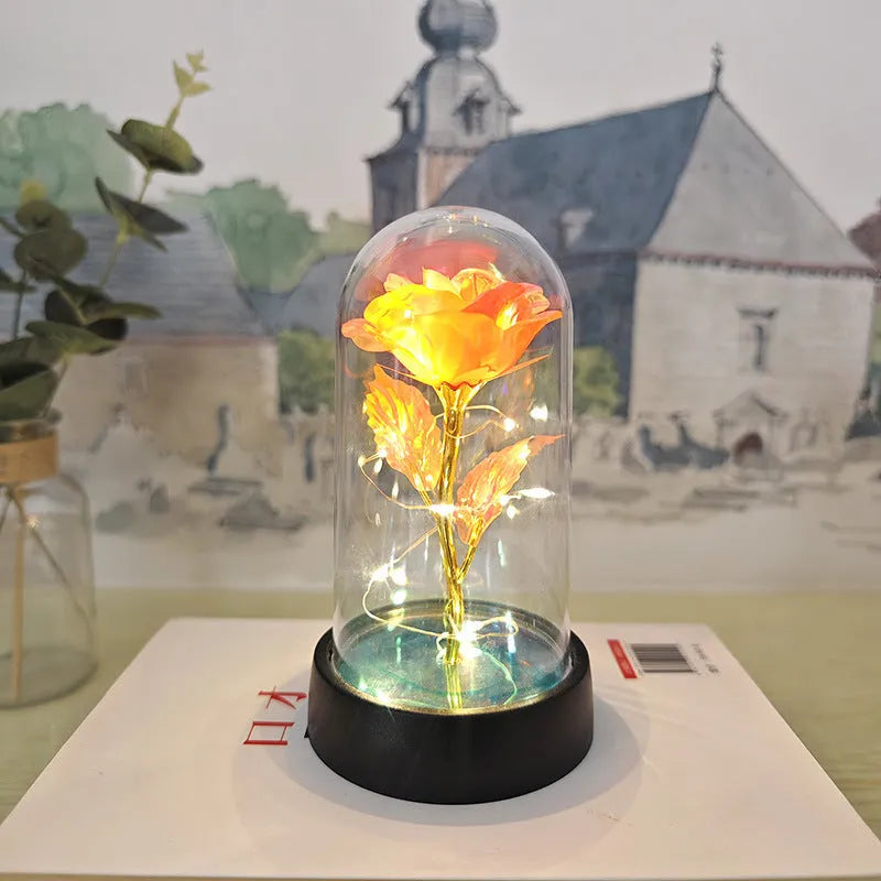 Small plastic night lamp with floral decoration and coloured light options on a black base.