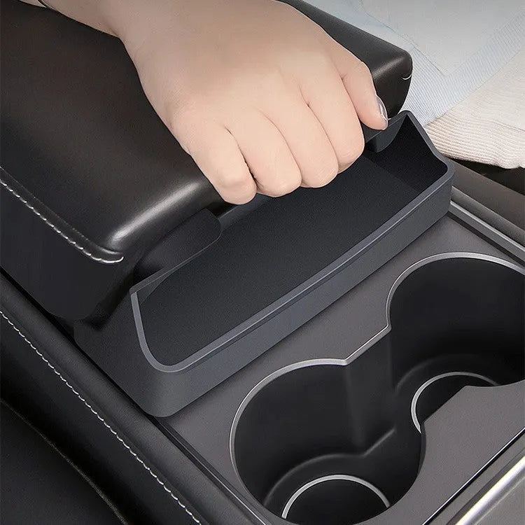 Black silicone sunglasses holder mounted on Tesla Model 3 centre console armrest