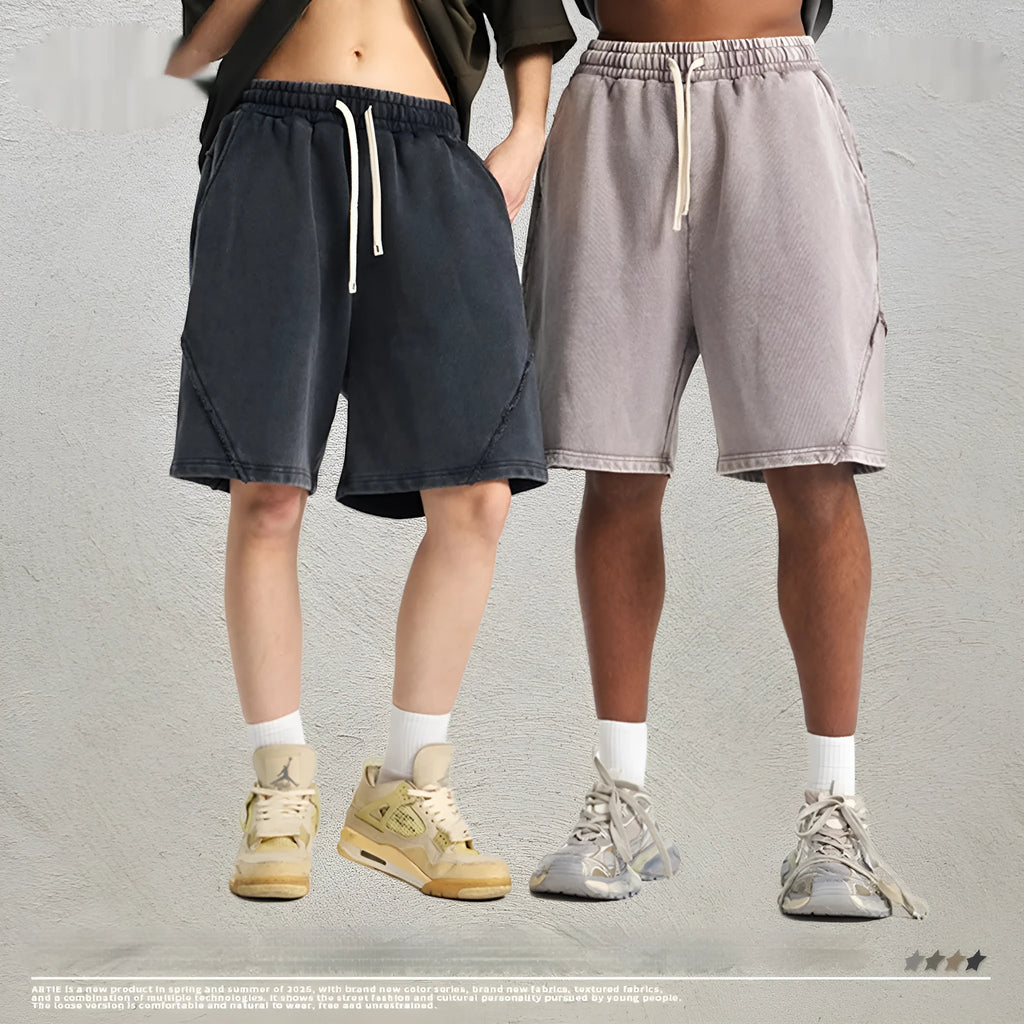 Man wearing loose fit batik-dyed cotton terry shorts in a casual street fashion setting.