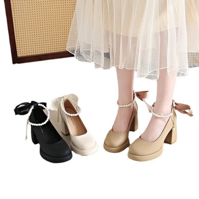 Women's beige Mary Jane shoes with chunky heel, round toe, and ankle strap with pearl buckle.