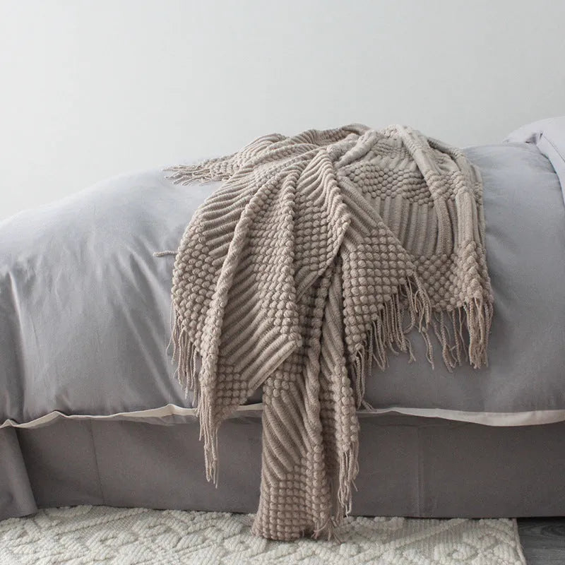 Small light grey polyester nap blanket folded, showing its 127cm by 170cm size.