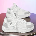 Men's white chunky sneakers with a cartoon totem pattern on the synthetic leather upper and a thick rubber sole.