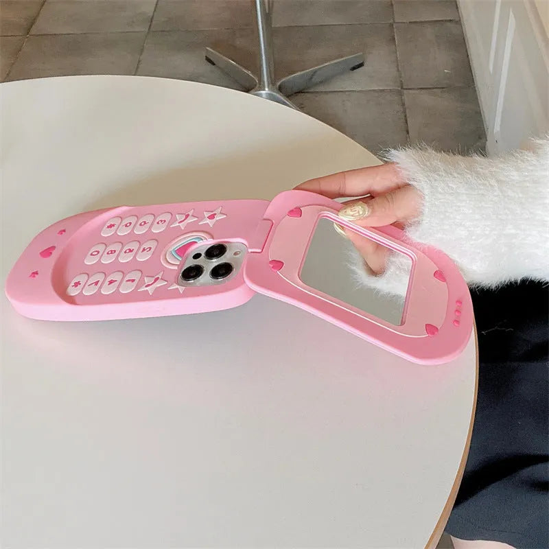 Pink silicone flip phone shape case with a mirror, designed for iPhone models.