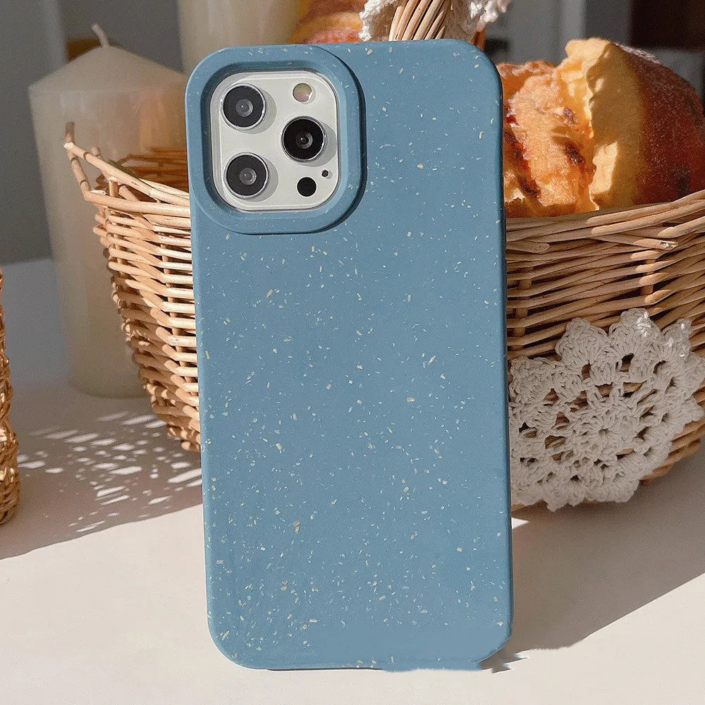 Fully degradable wheat straw bioplastic rear cover case for Apple iPhone on a table, shown in one of seven available colours.