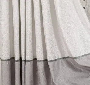 Simple blackout curtain panel hanging, showing light-blocking fabric and hook heading style.