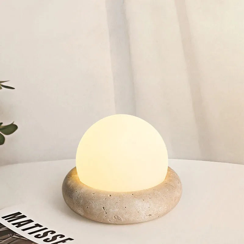 Cream modern bedside remote control night lamp with yellow cave stone light on bedside table