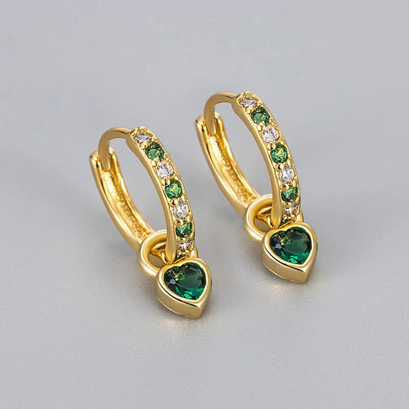 Women's fashion earrings with heart-shaped drops containing coloured gemstones in gold or white gold colour settings