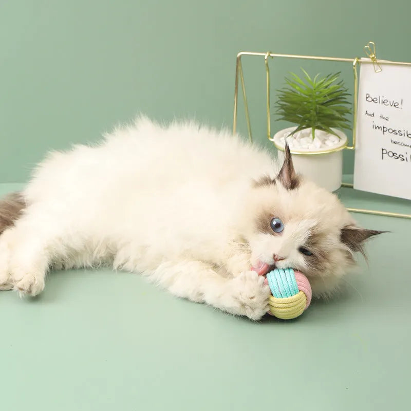 Handmade cotton cat plush hair ball toys in three colour options on white background