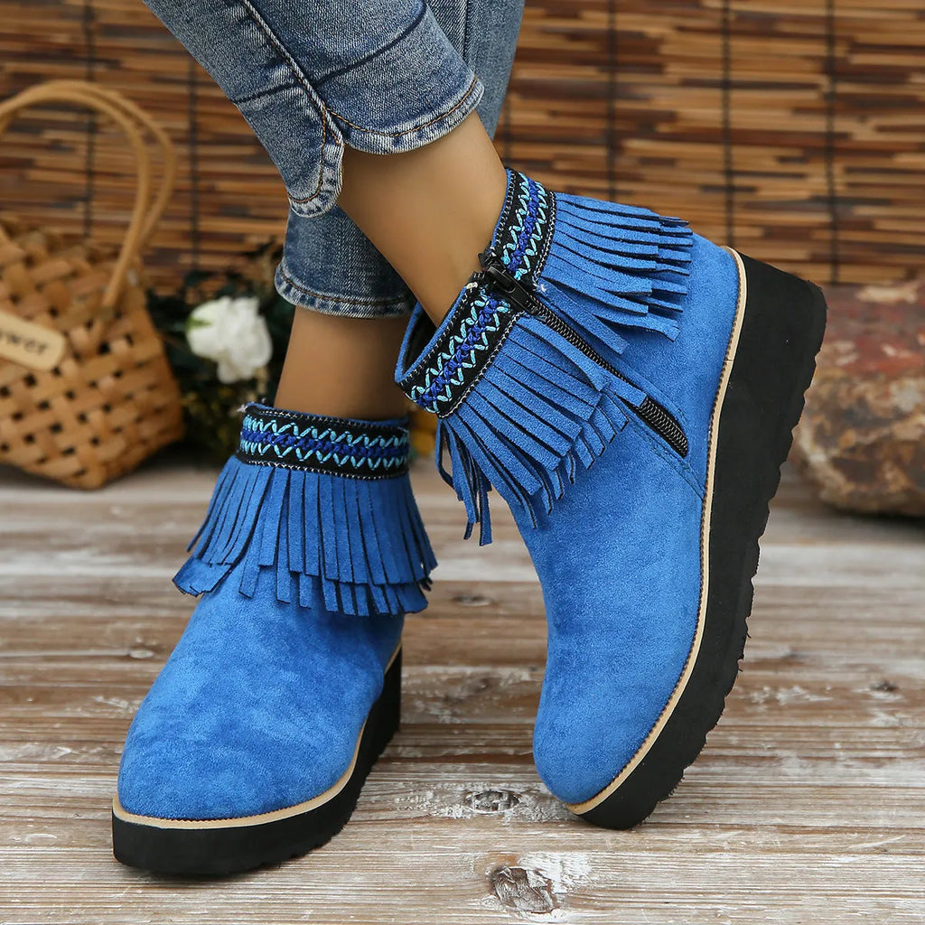 Women's dark brown suede wedge bootie with thick sole, side zipper, and tassel detail.
