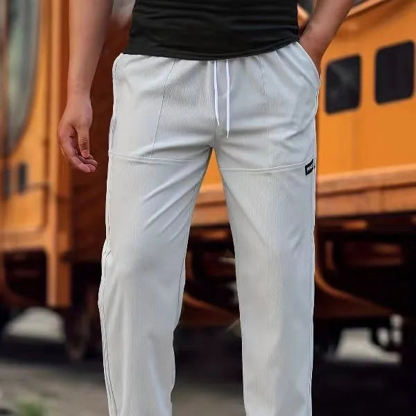 Men's light grey polyester trousers for spring and autumn casual wear, shown in Asian sizing.