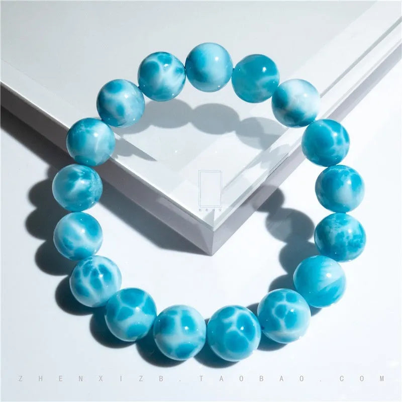Blue Maillard style Bodhi bracelet with a natural sea-pattern crystal stone and pearl beads on wrist.