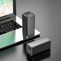 Black high power 65W metal laptop charging bank showing size and ports.