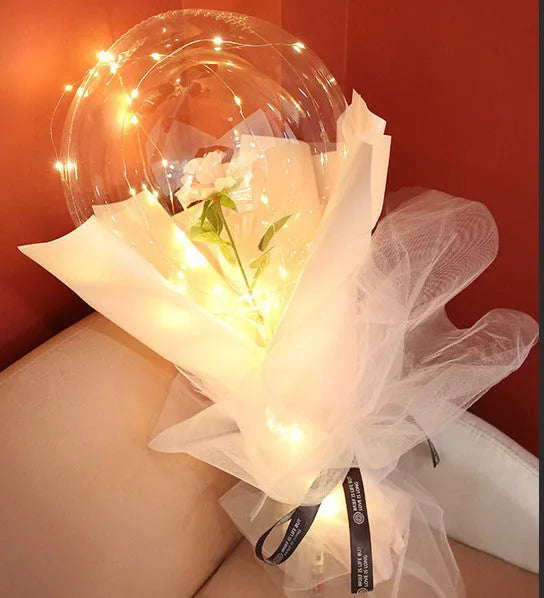 Transparent LED luminous balloon bouquet with artificial rose and glowing light inside, displayed as a DIY kit.