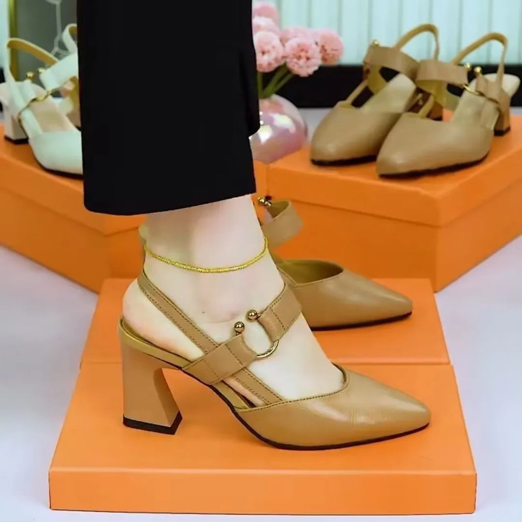 Women's apricot closed toe backless leather sandals with a chunky heel on a rubber sole.