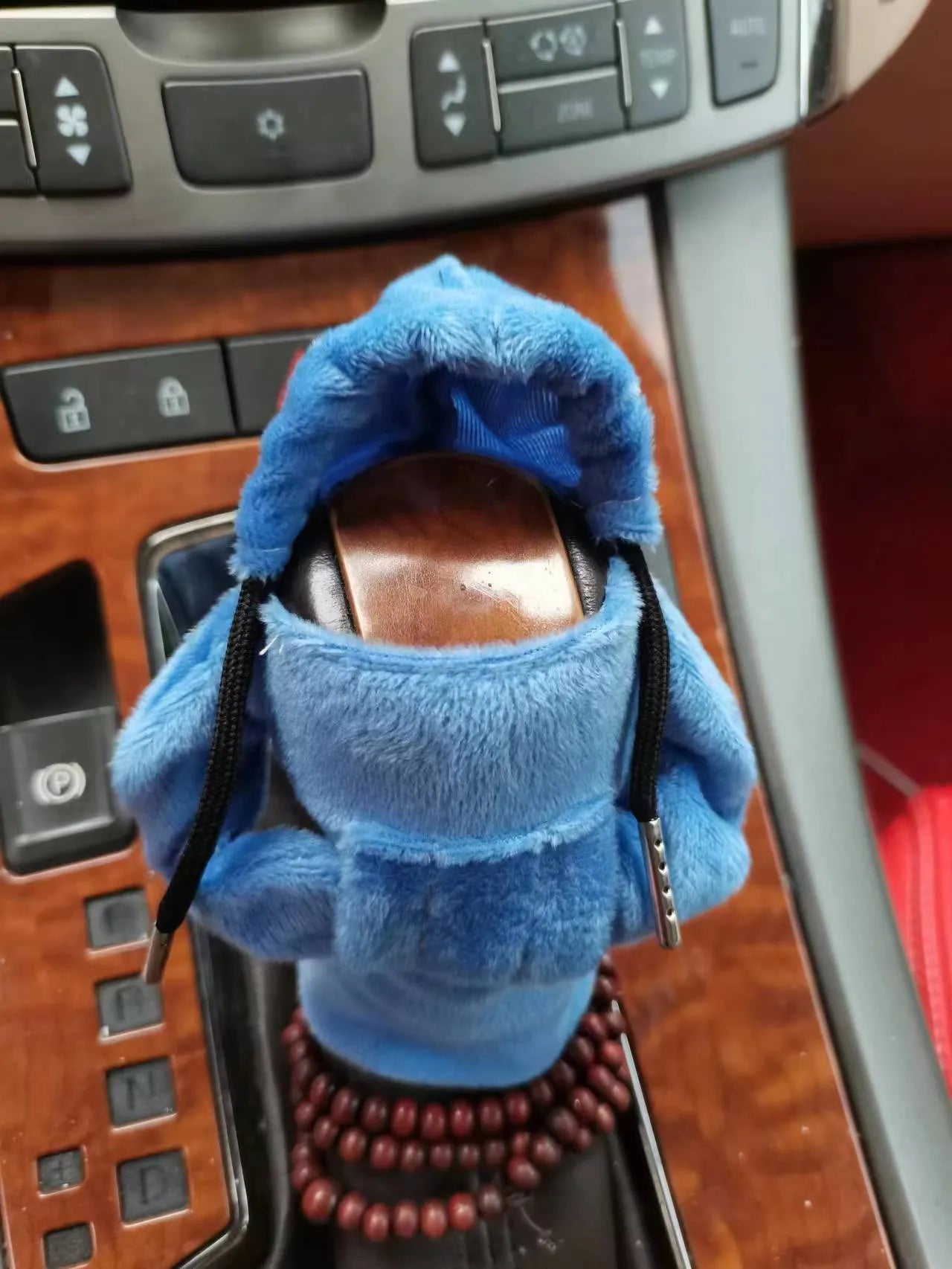 Soft Dutch velvet car gear handle cover in multiple colours on a gear stick.