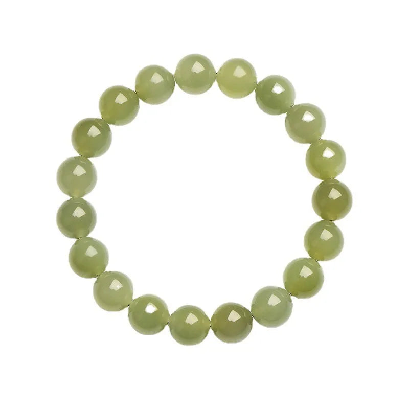 Polished Hetian jade ball bead bracelet in light and deep clear water colours on a wrist.
