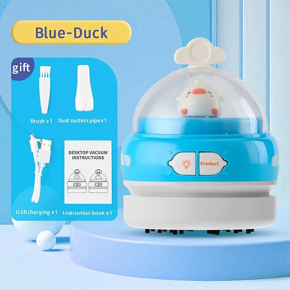 USB charging handheld desktop vacuum cleaner in blue rocket design on computer keyboard