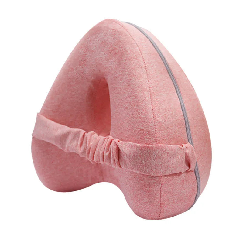 Love heart-shaped dark blue memory foam leg pillow for adults on a bed.