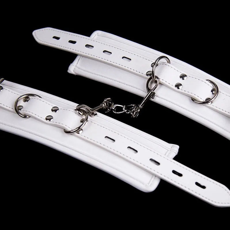 White PU sponge bondage restraint set showing handcuffs, foot cuffs and neck scarf for adjustable adult play
