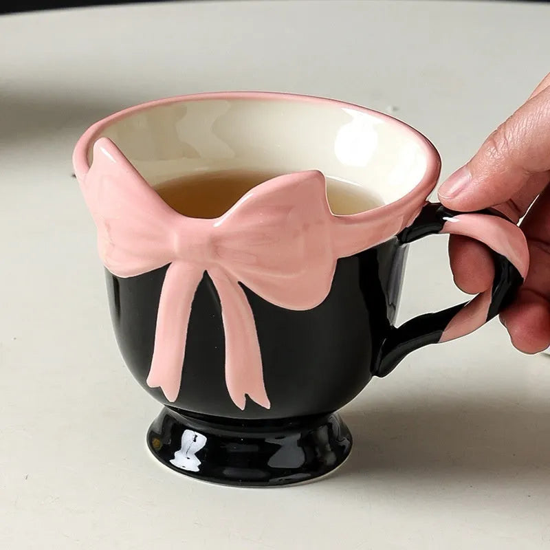 Ceramic mug with heart bow design in Black Pink colour, 301-400ml capacity.