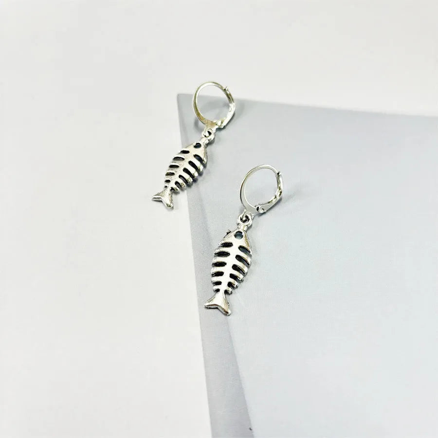 Women's fishbone pendant alloy necklace and matching earrings set on a white background