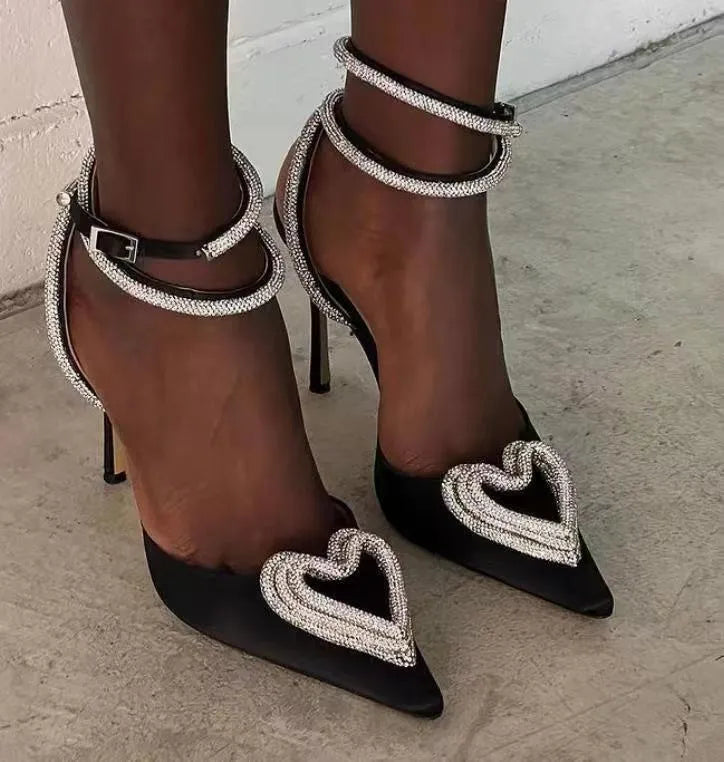 Women's pink satin sandals with pointed toe, heart-shaped rhinestone decoration, and ankle winding tape.