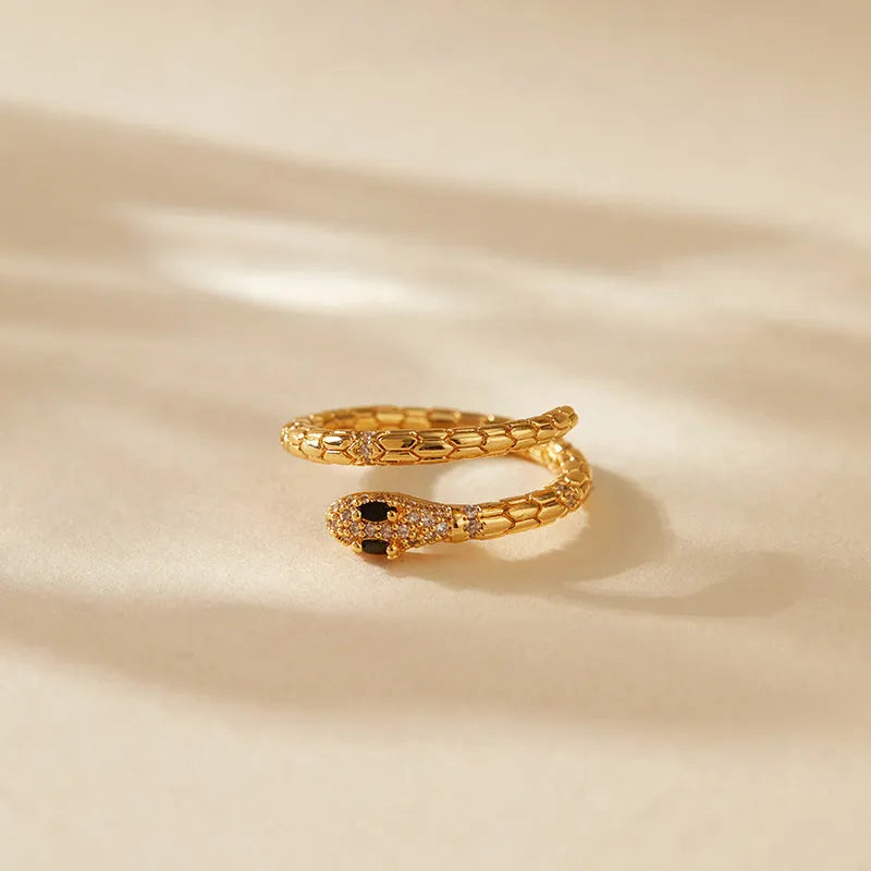 Adjustable snake-shaped copper ring with 18K gold colour plating on index finger