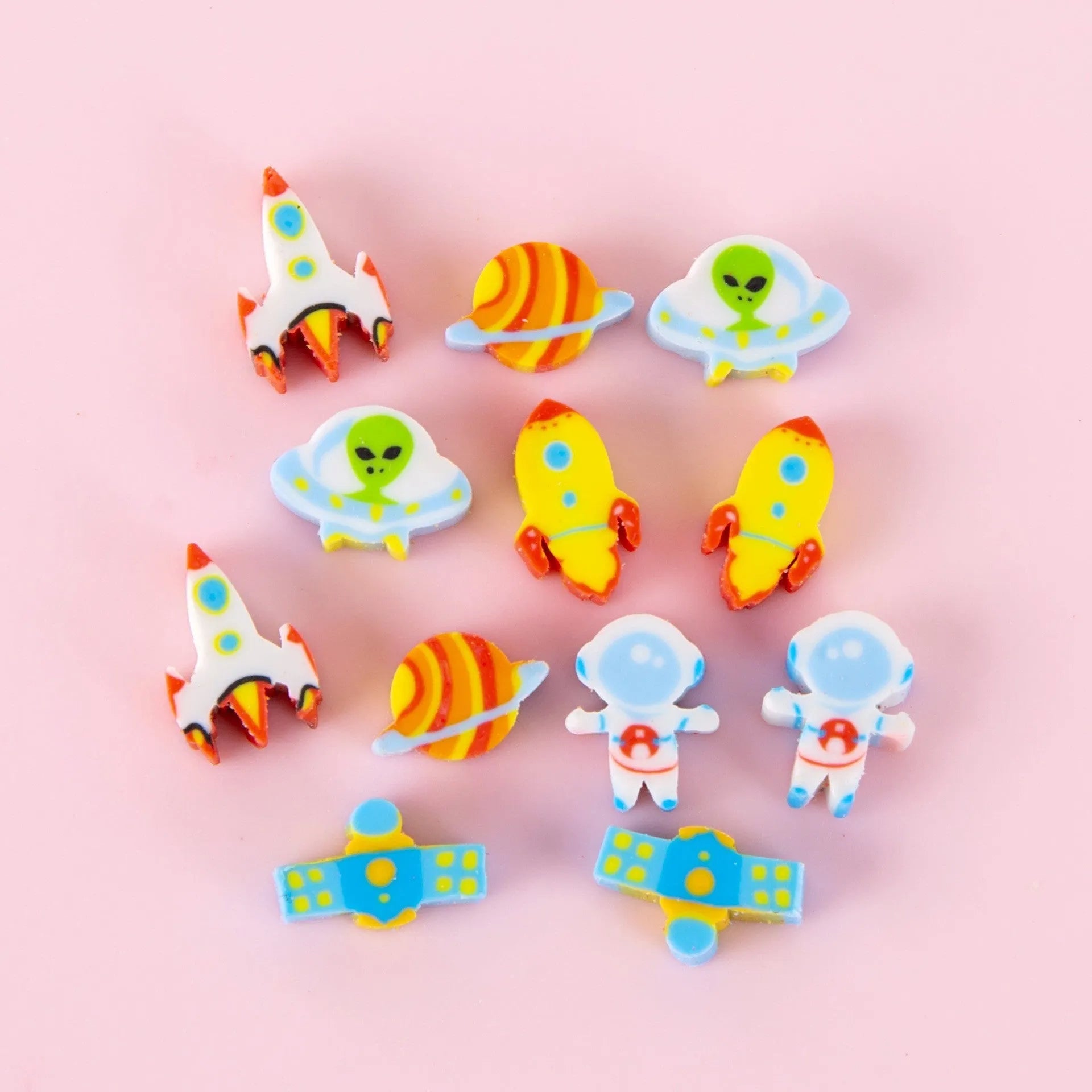 50 colourful cartoon mini erasers in pearlescent bags showing fruit, animal, and holiday designs