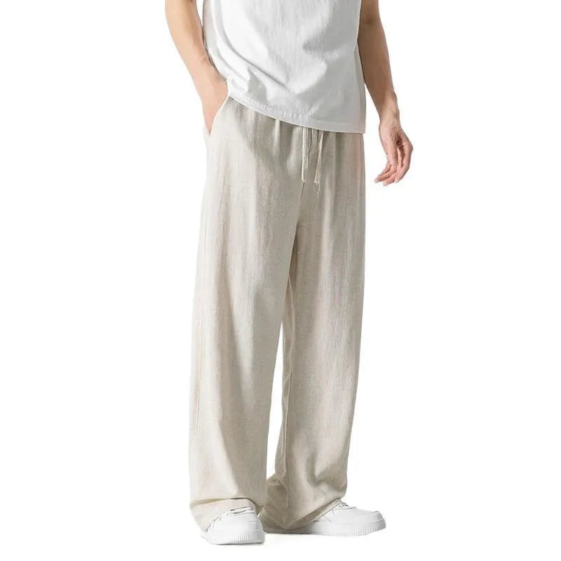 Men's beige linen casual trousers with a loose straight-leg fit and drawstring waist.