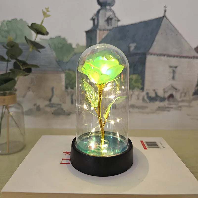 Small plastic night lamp with floral decoration and coloured light options on a black base.