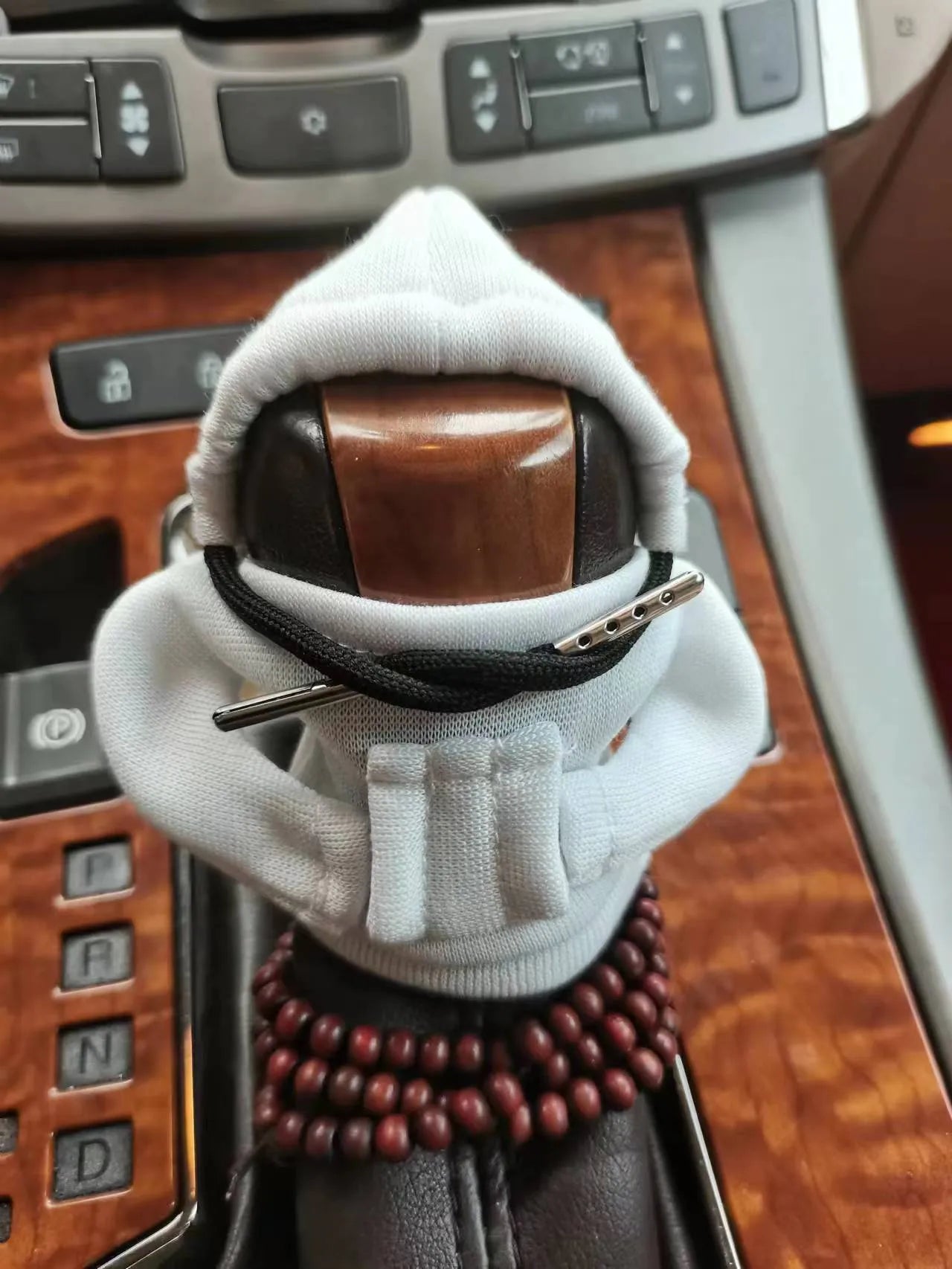 Soft Dutch velvet car gear handle cover in multiple colours on a gear stick.