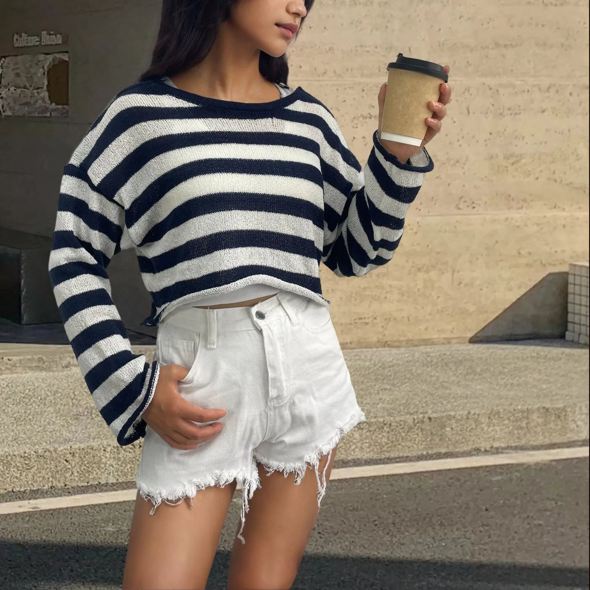 A striped long-sleeved pullover sweater with a cropped front and back design, shown in a selected colour.