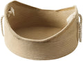 A rectangular wicker cat bed basket with a corrugated cardboard scratching surface on its side.
