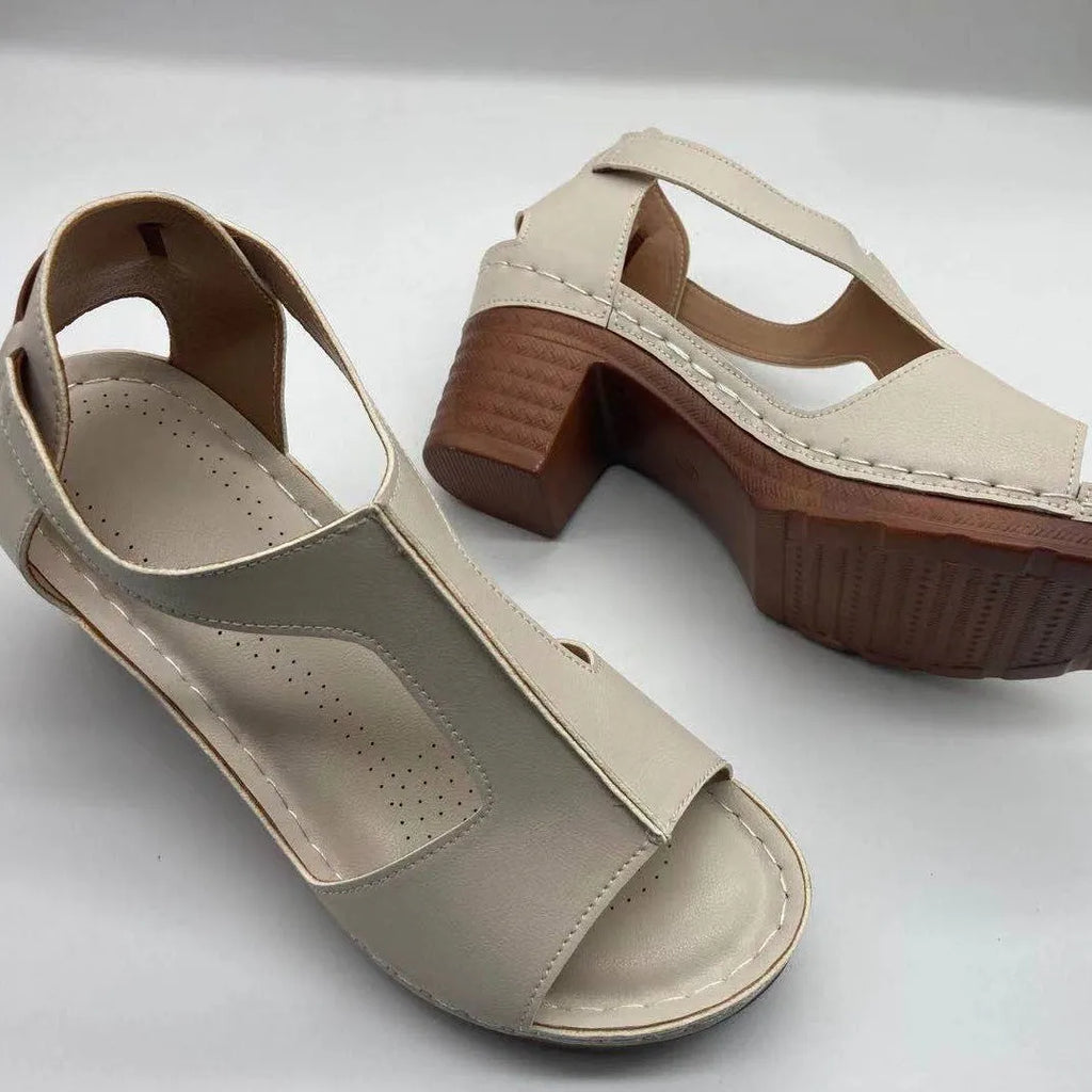 Plus size women's beige open toe wedge sandals with a buckle strap and low heel on a white background.