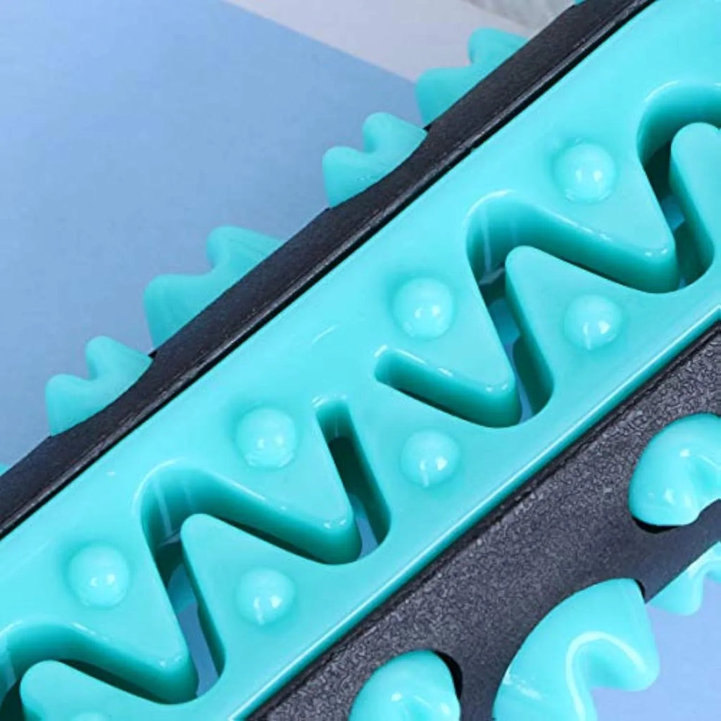 Natural rubber dog toothbrush chew toy in blue, shown next to a small dog for scale