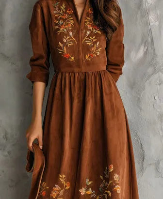 Brown polyester midi dress with floral embroidery detail and long sleeves on a hanger.
