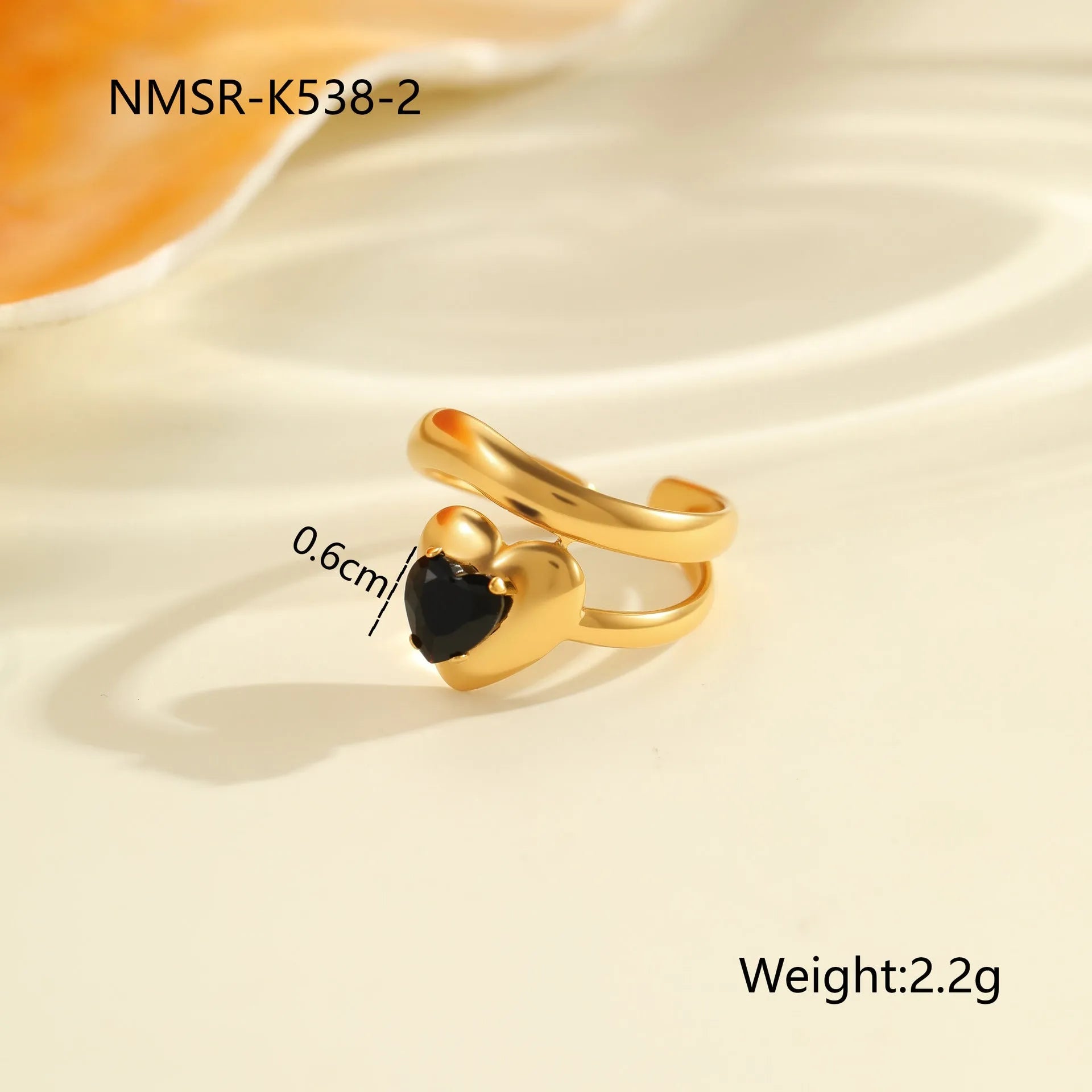 Geometric open mouth titanium steel ring for women on a plain background.
