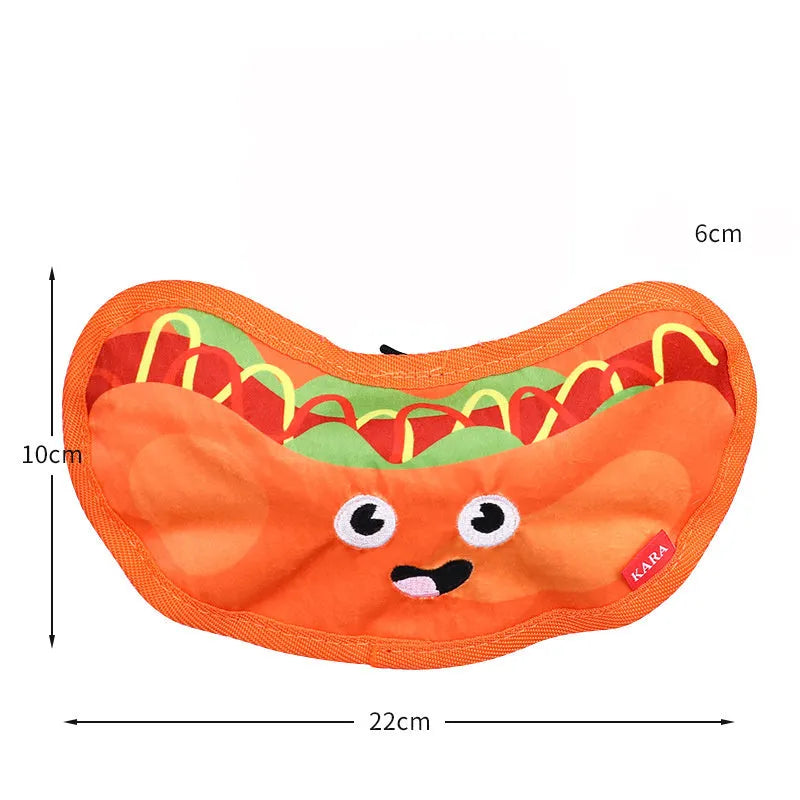 Set of four food-shaped dog toys: hamburger, fries, hot dog, and pizza, with vivid colours.