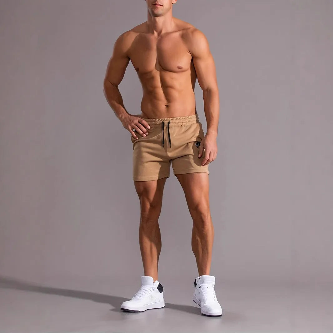 Men's khaki sports shorts with coconut print pattern showing straight cut and micro-elastic polyester fabric