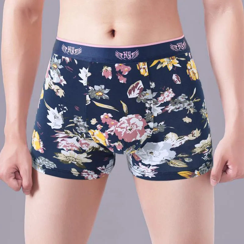 Men's cotton boxer shorts in a floral pattern, showing the mid-waist fit and U-shaped convex design.