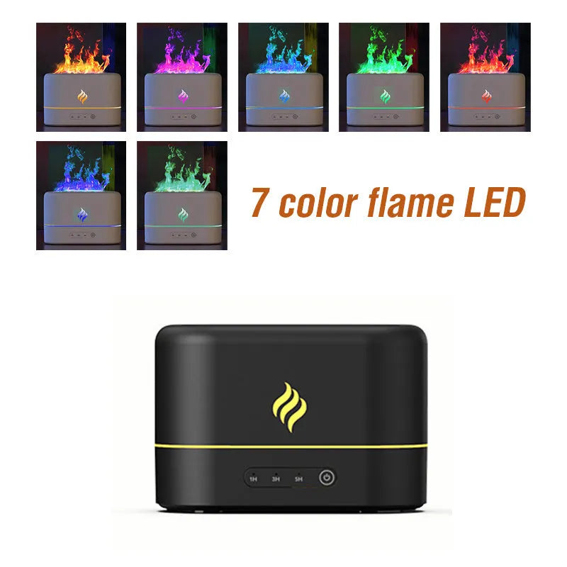Black USB humidifier displaying a seven-colour flame effect on a desk next to a plant.