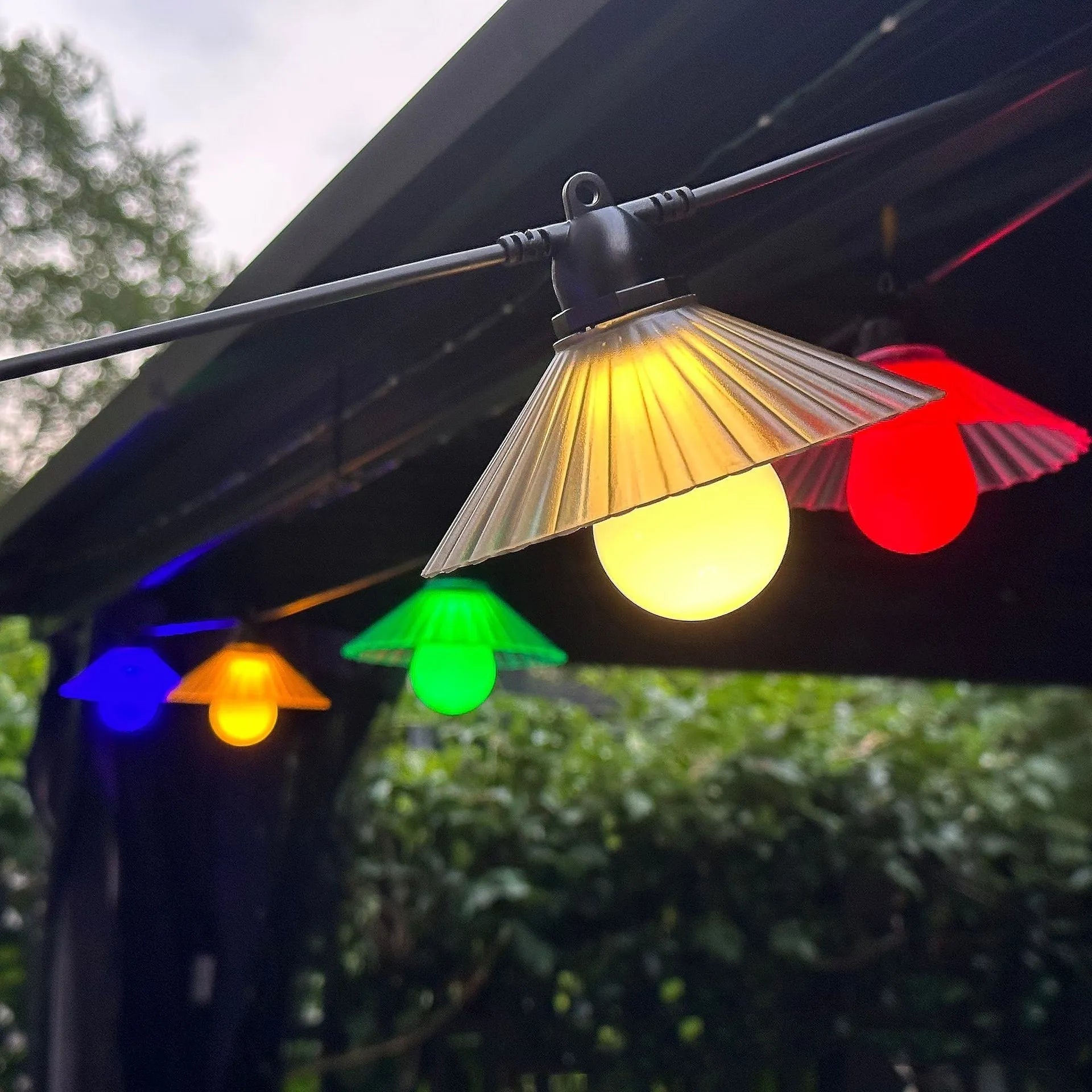 Outdoor LED string lights with flower-shaped bulbs in garden setting showing IP65 waterproof rating