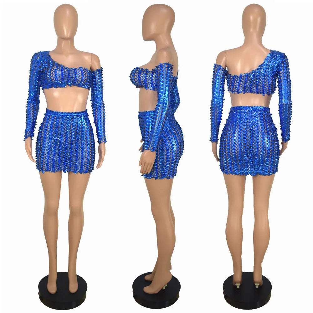 Women's black hollow-out two-piece set featuring a sleeveless top and short skirt with splicing detail.