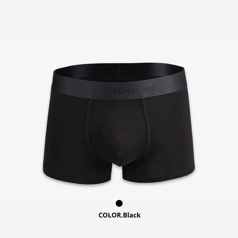 Men's solid colour cotton boxers in black, white, silver grey, and light green laid flat