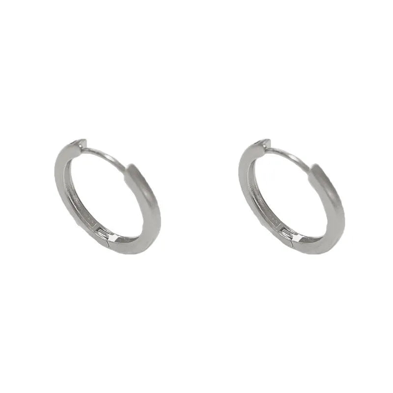 Geometric eyelet ear clips with circular design in gold or silver tone