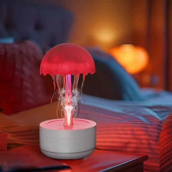 White jellyfish-shaped humidifier and essential oil diffuser with colourful LED night light on a desktop.